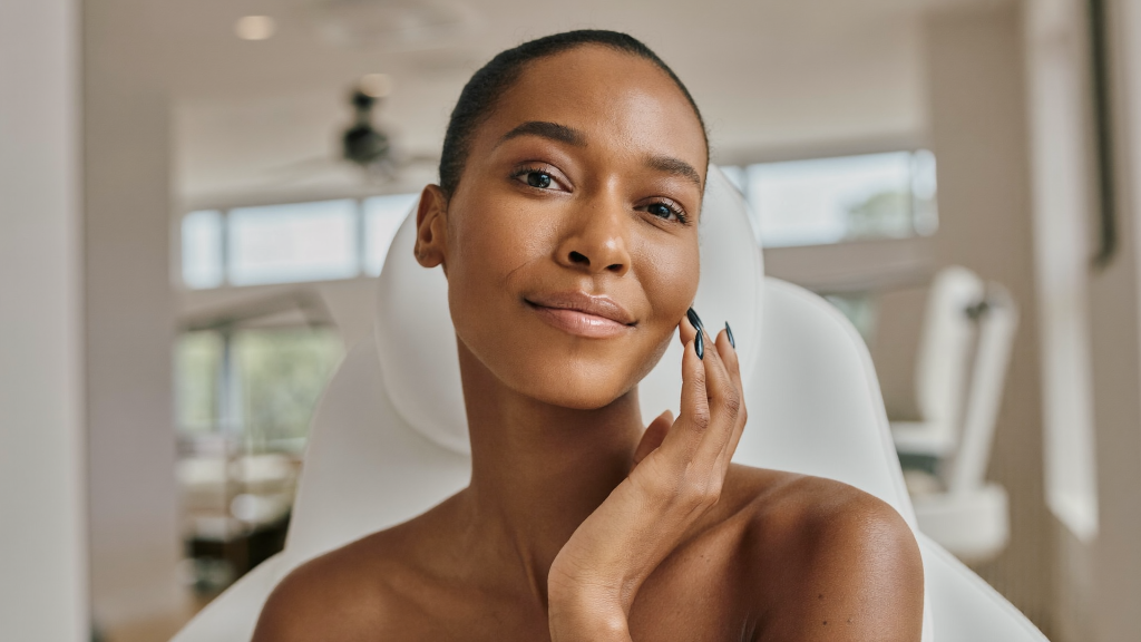 Woman in her 40s with smooth natural skin at a premium aesthetics clinic